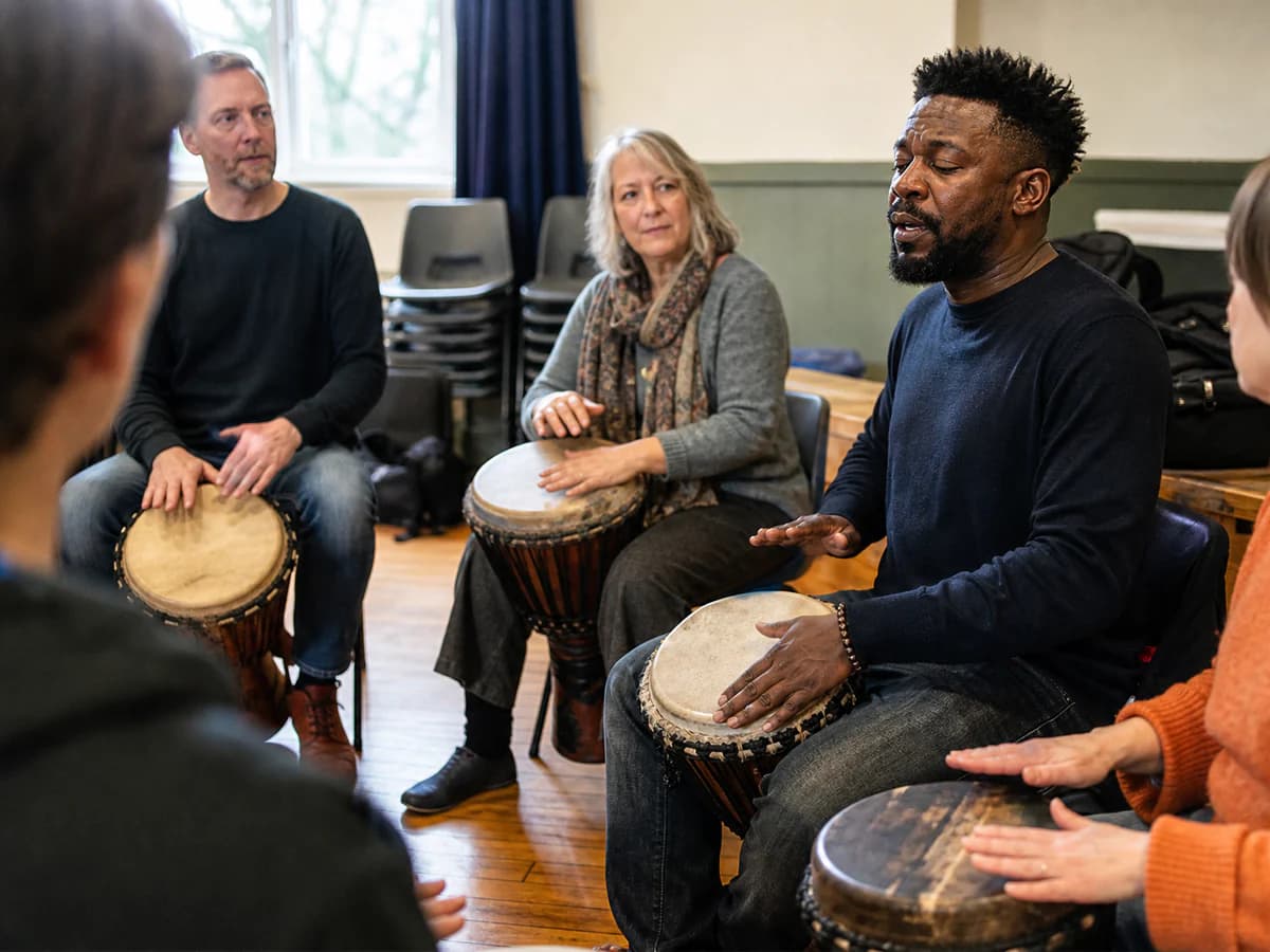 Serge Tebu leading an engaging rhythm workshop with a group seated in a circle