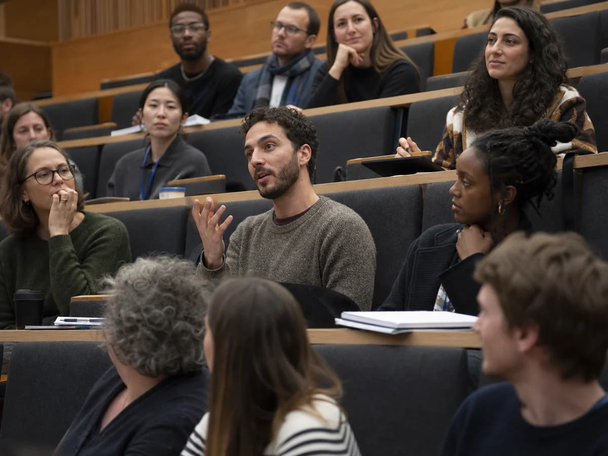 Audience listening in a university auditorium during a lecture
