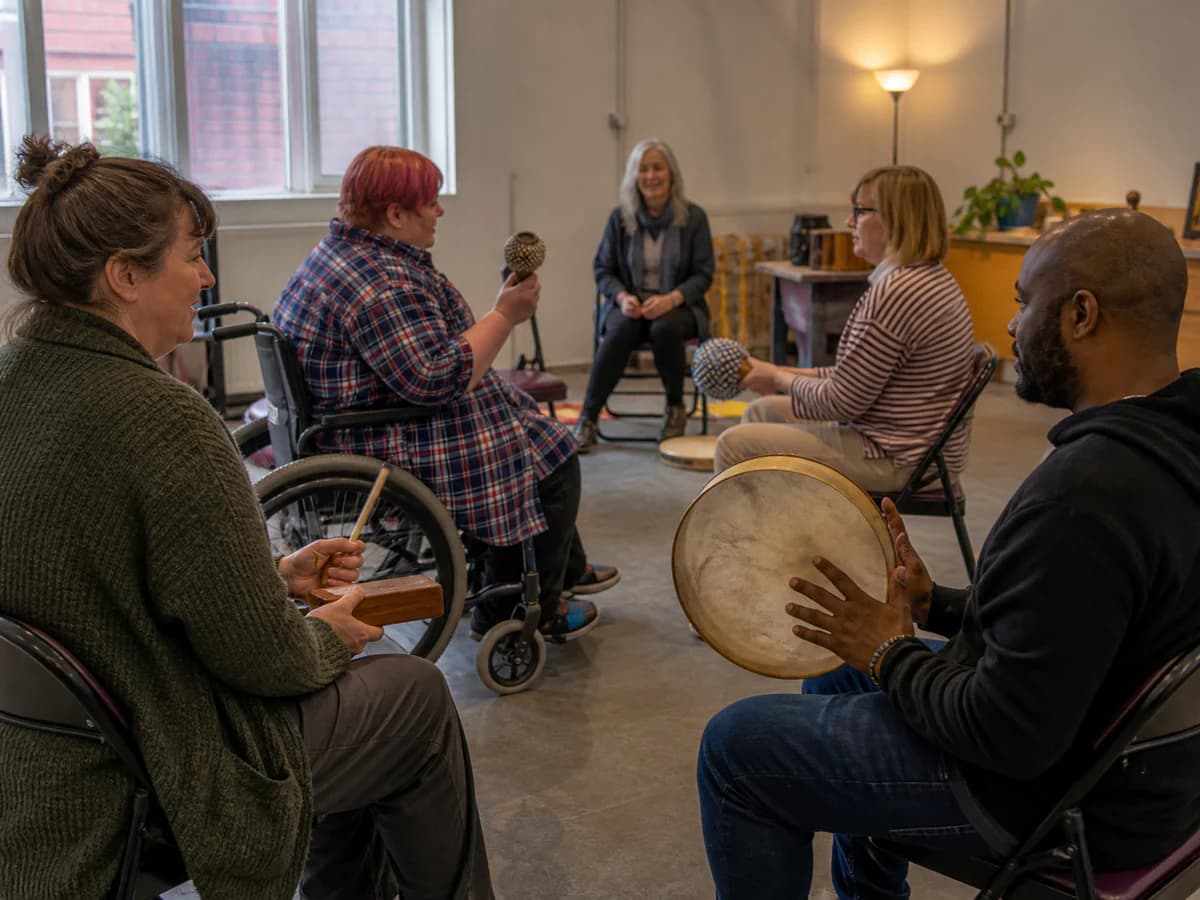 Adult workshop participants collaborating on rhythm arrangements