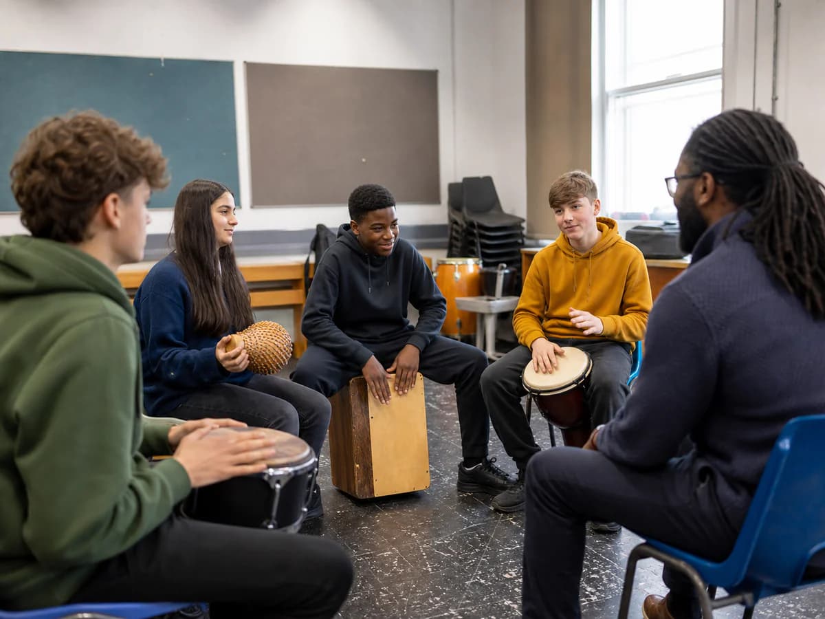 Youth workshop in a bright hall with young participants playing rhythm patterns