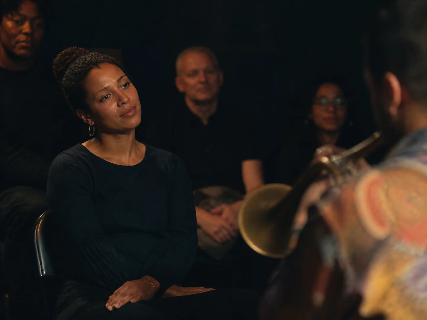 Audience member captivated and listening intently during an Afro-jazz live concert