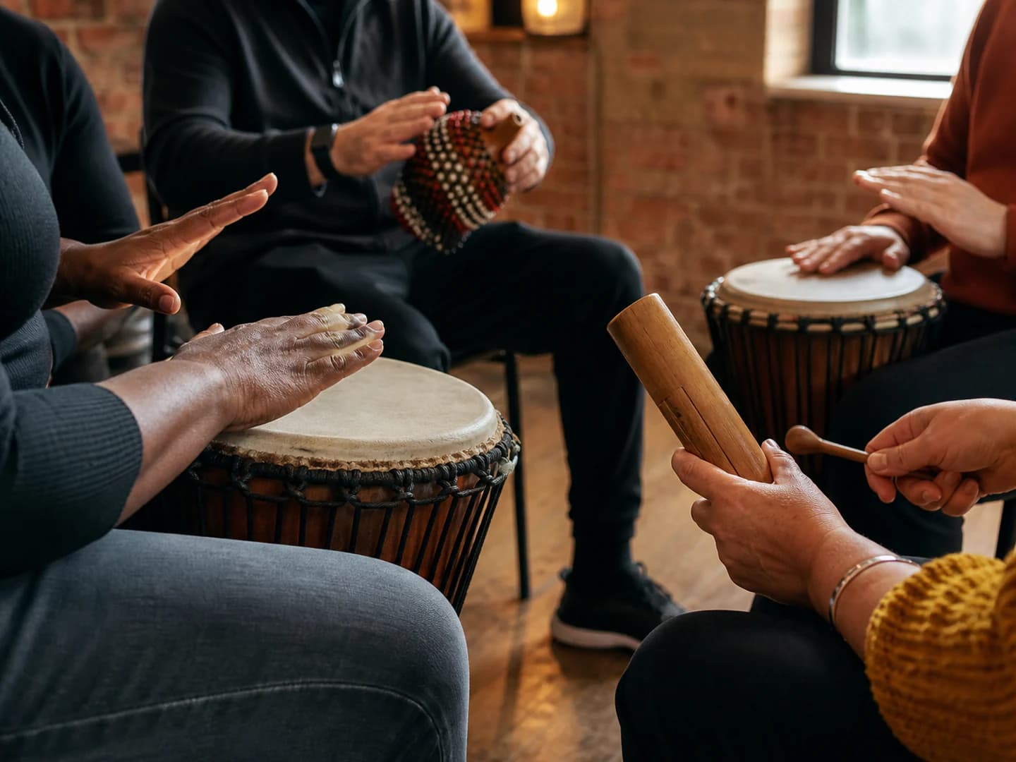 Hands on traditional West African percussion instruments in a warm studio